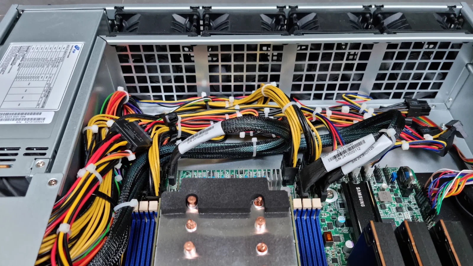 I flipped all four fans to have front to back airflow. In this configuration, the fan labels are not visible from inside the case.